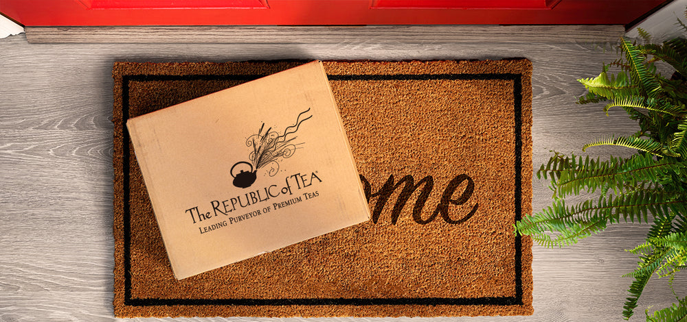 Doormat with 'The Republic of Tea' logo on a wooden floor.
