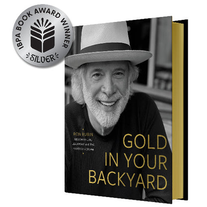 Book titled 'Gold in Your Backyard' with a silver award badge on a white background